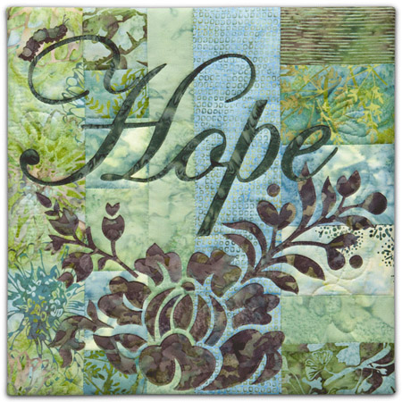 Quilt block with the word "Hope," stylized flowers and a catepillar in purple, blue, and green floral patterns