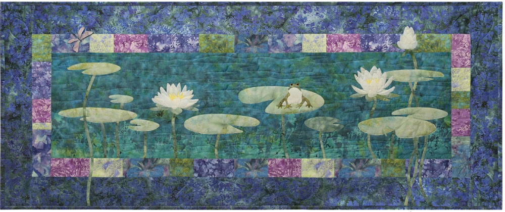 Quilt block showing frog in a pond with lily pads