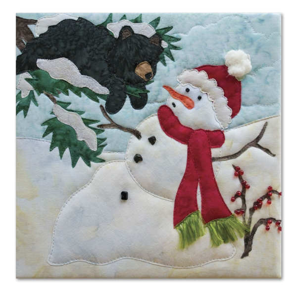 Quilt block of a snowman melting on a bright day, with a bear in a tree