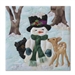 Quilt block of a bear cub and a fawn cuddling with a snowman during the chilly first frost