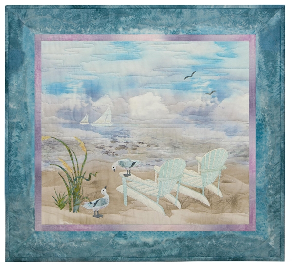 Quilt block of two Adirondack chairs on the beach, looking out at sailboats on the ocean.