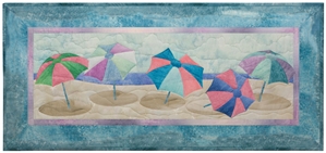 Quilt block of brightly-colored beach umbrellas.