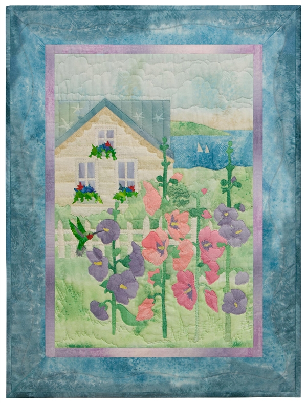 Quilt block of summer house that overlooks the bay, with cheerful pink and purple hollyhock flowers in the front yard.