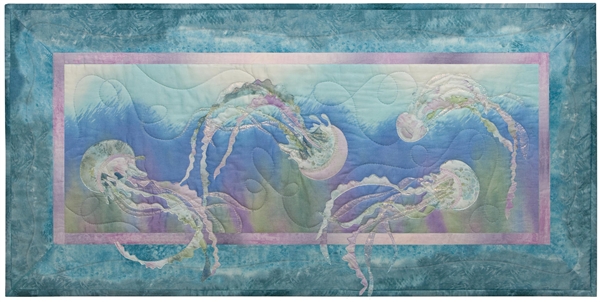 Quilt block of jellyfish dancing under the waves.