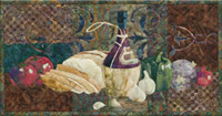 Italian style quilt block, showing a bottle of red wine, as well as the makings of a delicious bruschetta, with crusty bread, tomatoes, garlic, onion, and bell peppers