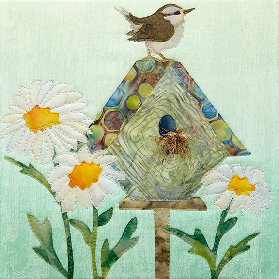 a fabric panel with a birdhouse, a wren, and shasta daisies