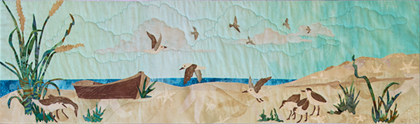 Quilt block of an empty boat on the beach, with sandpipers circling and looking for food.