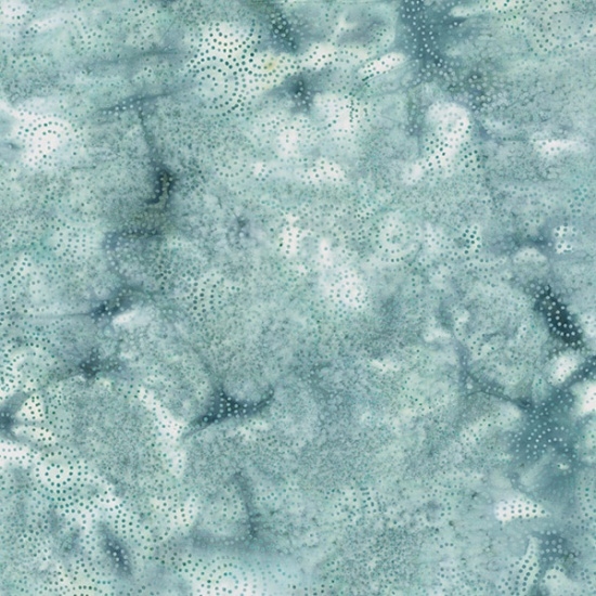 Spiral dot pattern batik fabric on a marbled light blue-green background
