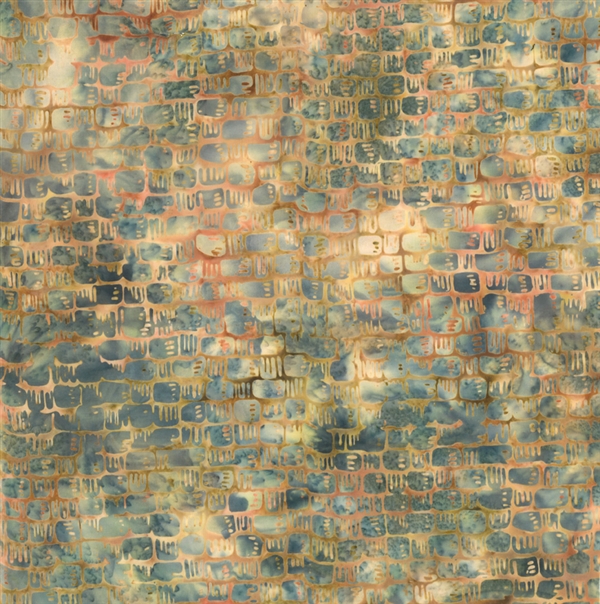 Basket weave pattern batik fabric in golden yellows and oranges with a cream and dusty blue mottled background.