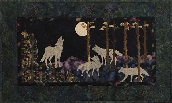 A wolf pack hunts by the light of the full moon.