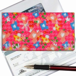 Lenticular checkbook cover with mushrooms, t-shirts, and stars on a pink background, depth