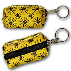 Lenticular purse key chain with black spinning wheels on yellow background, animation