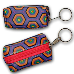 Lenticular purse key chain with kaleidoscope colored hexagons on a purple background, color changing