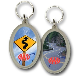 Lenticular acrylic key chain with oval shaped, custom design, AAA curvy road sign on a cloudy sky, flip