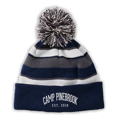 Knit beanie with pom. Embroidered with Camp Pinebrook logo.