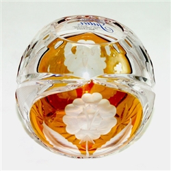 This is genuine Polish hand-cut leaded crystal with a floral design.  Amber colored background.