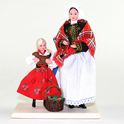The Polish Easter tradition of taking your Easter basket to church for the blessing of the food is depicted here.  Mother and daughter are in their traditional Krakow costumes bearing their filled Easter basket as well as a bread baked in the shape of the