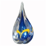 Three-sided art glass paperweight, with a cobalt-blue interior core, surrounded by a yellow ribbon and a few bubbles, in a classic teardrop shape. Each piece is hand blown and hand finished in Poland. Made with the highest quality craftsmanship and hand-s