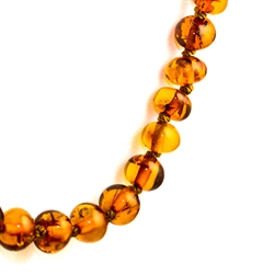 Delicate honey amber beads rounded and knotted between each bead.  Beads are about .5cm in diameter.