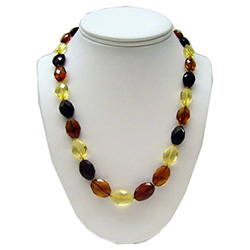 Alternating light, dark and clear multi-faceted and polished amber beads.  Each bead is knotted.