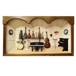 Poland has a long history of craftsmen working with wood in southern Poland. Their workshops produce beautiful hand made boxes, plates and carvings.  This shadow box is a look inside a traditional Polish music room.