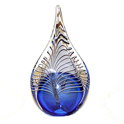 Two-sided art glass paperweight, with a gorgeous blue interior core with a peackock feather design, in a classic teardrop shape.  Each piece is hand blown in Poland.  Made with the highest quality craftsmanship and hand-signed by the artist.