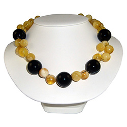 A stunning combination of medium amber and large onyx beads artistically woven together in multi-strands.  Adjusts to three lengths: 22" , 19" and 17".