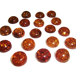 Approx .5" x .25" thick - 10mm x 6mm thick.  These are round domed amber cabochons.  Price is per piece.