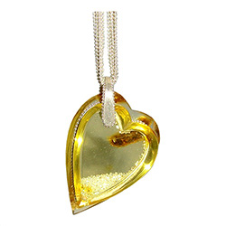 Exquisite amber heart pendant filled with tiny Czech Signity Cubic Zirconia crystals.  This pendant is composed of two pieces of clear heart shaped amber slices to create a chamber into which the artist has poured tiny Czech crystals