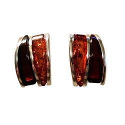 Nicely detailed in sterling silver. Two slices of attractive curve shaped amber cabochons.