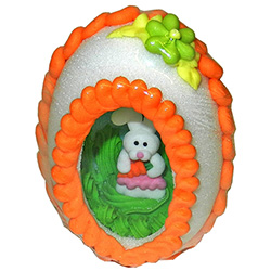 Medium size sugar panoramic Easter Egg with a miniature sugar Easter chick or bunny sitting on green "sugar grass" inside.   Floral design on the outside, surrounded by a decorative band of icing.  Packaged in a very nice display box.