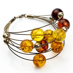 Eight beautiful strands of round amber beads in three shades on silver wire.  Each amber bead is separated by a silver sphere.