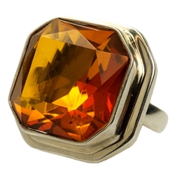 A perfectly cut square piece of faceted cognac colored amber set in sterling silver.