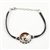 Sterling Silver and Baltic amber Aquarius zodiac sign charm on a durable cord made of black rubber.