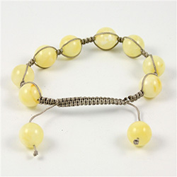 This fine macrame bracelet is made with light custard colored amber.  This bracelet includes a grey cord and a slide clasp to fit most wrists.