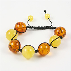 This fine macrame bracelet is made with custard and honey colored amber.  This bracelet includes dark brown cord and a slide clasp to fit most wrists.