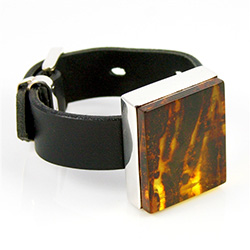 Large block of clear honey amber (1.25" x 1.5" - 3cm x 4cm) with a dark striped background and set in sterling silver with an adjustable belt bracelet (6.25" - 8.5" - 16cm - 22cm long).