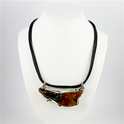 Two contrasting amber nuggets framed in an artistic brushed silver setting.