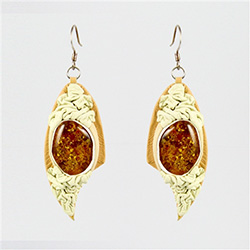 Two sparkling honey amber cabochons set in white leather.  2.5" long.  We have several sets of these so they will vary from set to set as they are all hand made.