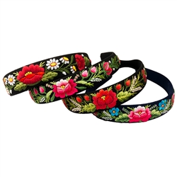 This is a flexible headband that has been covered in black or navy blue material that has been hand embroidered in a Lowicz style floral pattern. Made in Lowicz, Poland. No two are alike.