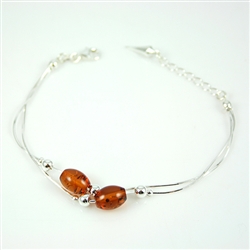 Oval honey amber beads set in sterling silver.