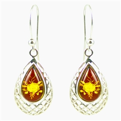 A beautiful floral cameo is carved into the back of each tear drop shaped amber cabochon.