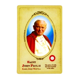 This unique prayer card contains a third class relics on the front with the prayer on the back. Please note that these are third class relics and are not first or second class but only a piece of cloth touched to his relic.