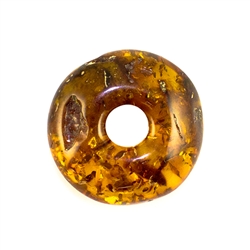 Very impressive polished doughnut shaped honey amber stone for pendant use. Weighs 6g.