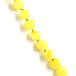 This beautiful beaded amber necklace features small rounded Baltic custard color amber beads strung together, and finished with an amber closure. The beads are knotted between each bead.