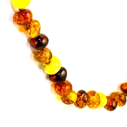 Lovely necklace composed of cherry, custard, light and dark honey Amber. Oval Amber Bead size approx .2" - .25" diameter. Gold colored cord w/ knot between each bead. Gold claw clasp closure.