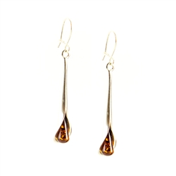 Drops of honey amber wrapped in silver in a calla lily shape.  Stylish and unique.