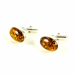 Beautiful pair of oval shaped silver cuff links highlighted with oval amber centers.