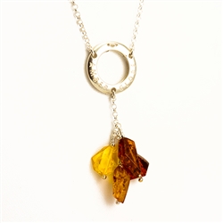 This beautiful amber necklace features a silver circle stamped "Amber Globe" from which four amber stones are suspended.