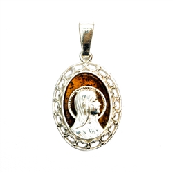 Beautiful oval shaped sterling silver Madonna on a background of natural amber.